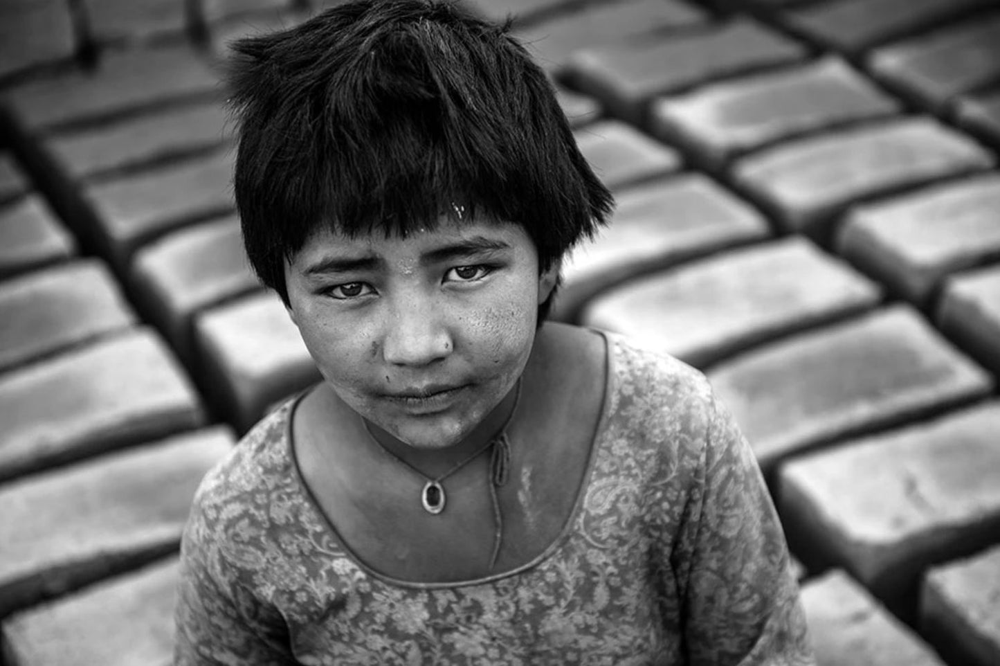 'A girl child from Bihar helping her father to make house in Ladakh' - Aman Chotani original print